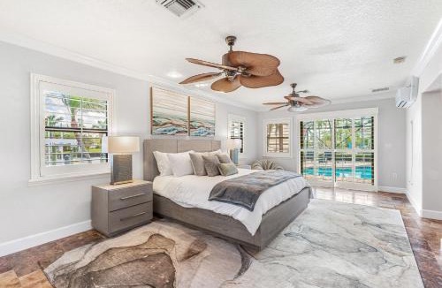 Cocoa Isles Villa | Casa De Olas - Waterfront Luxe Home - Heated Pool - Game Room - Boat Lift - Minutes to Beach