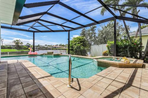 Riverfront Luxury with Heated Pool, Spa & Private Dock - Sunny Shores Escape